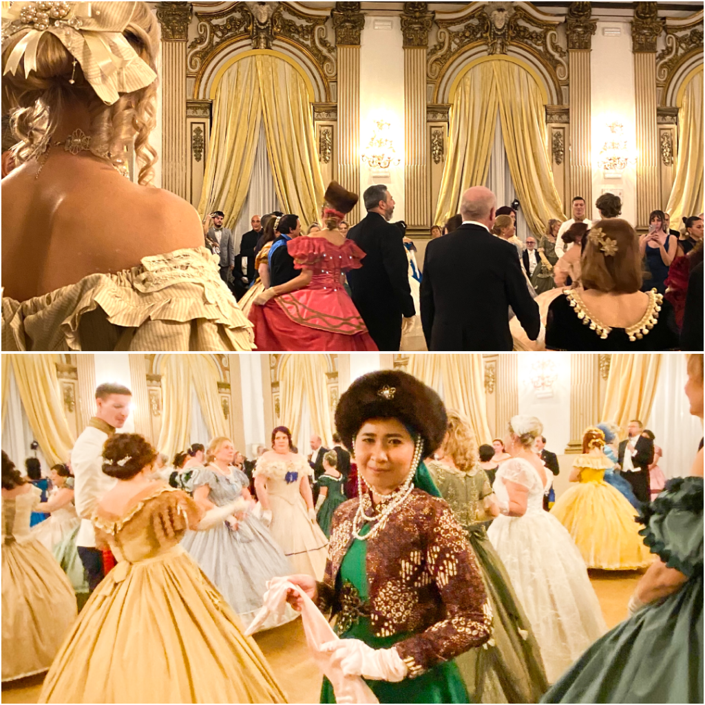 A ballroom scene with elegantly dressed participants in historical attire engaged in a dance, featuring elaborate costumes and lavish decor.